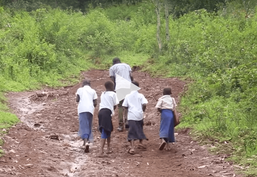 an adult and 4 kids walking away