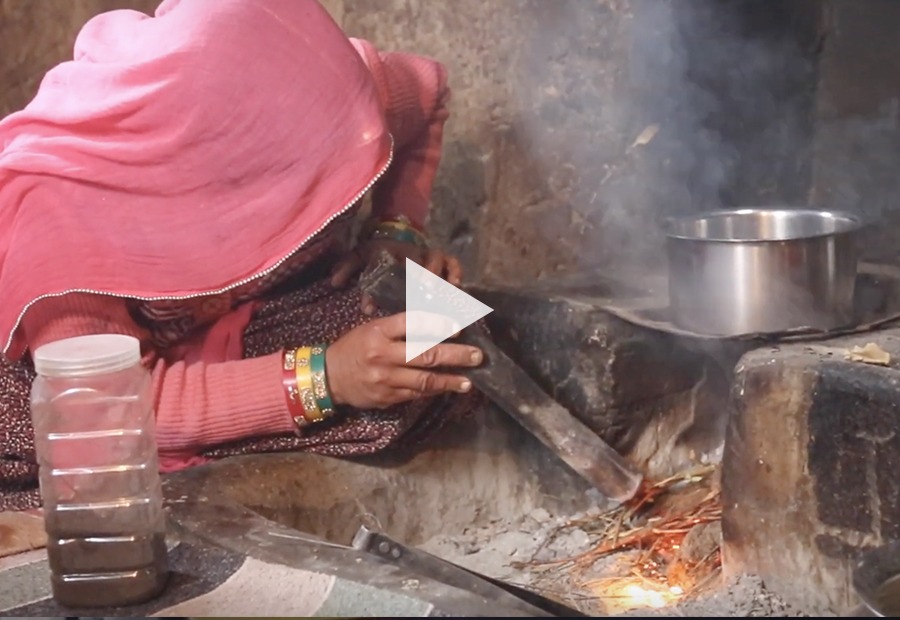 woman turning on kitchen fire